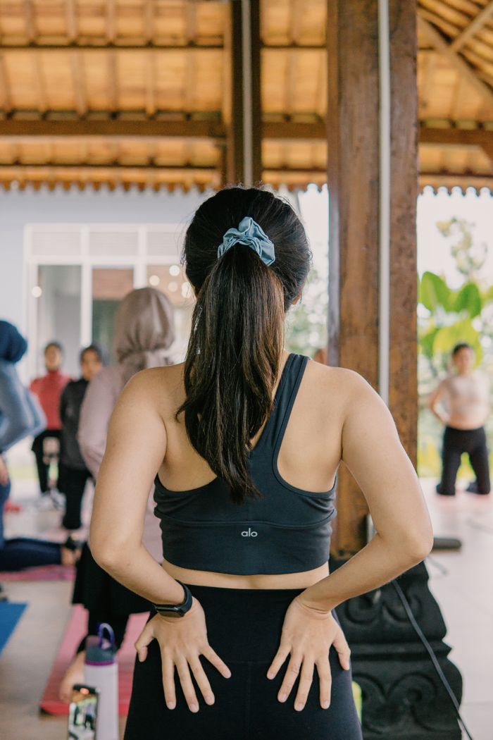 services-02 Women practicing yoga outdoors in a serene setting in Java, Indonesia.