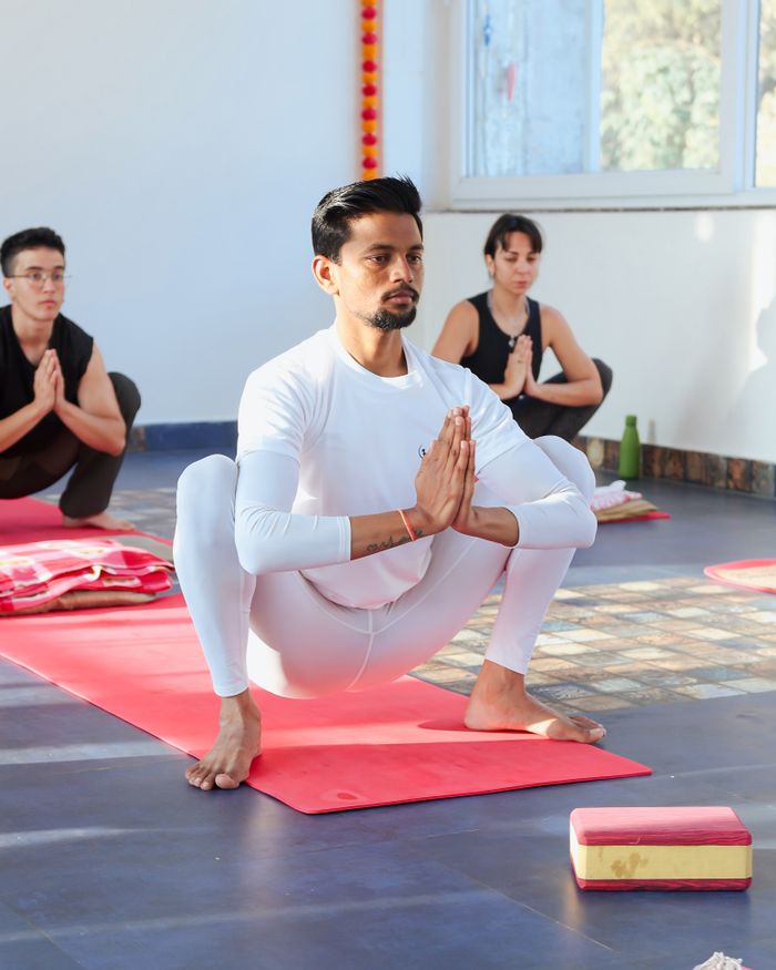 Crafting Captivating Headlines: Your awesome post title goes here A diverse group of people practicing yoga and meditation indoors with focused concentration.